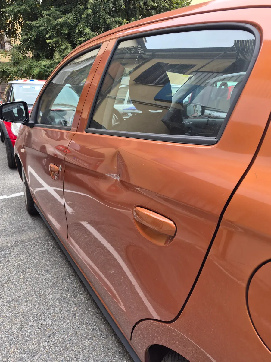 Dent on the rear door — Before