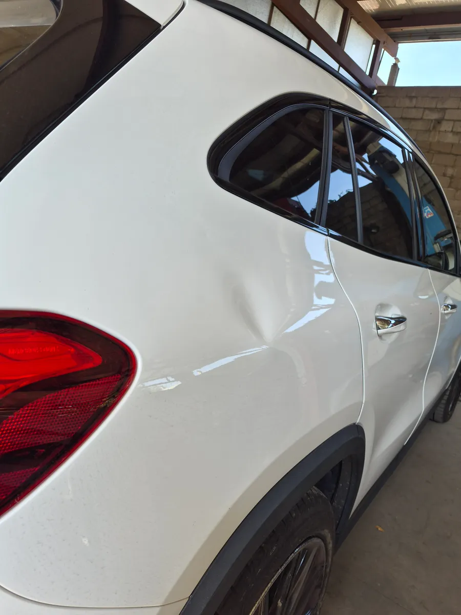 Dent on the rear quarter panel — Before